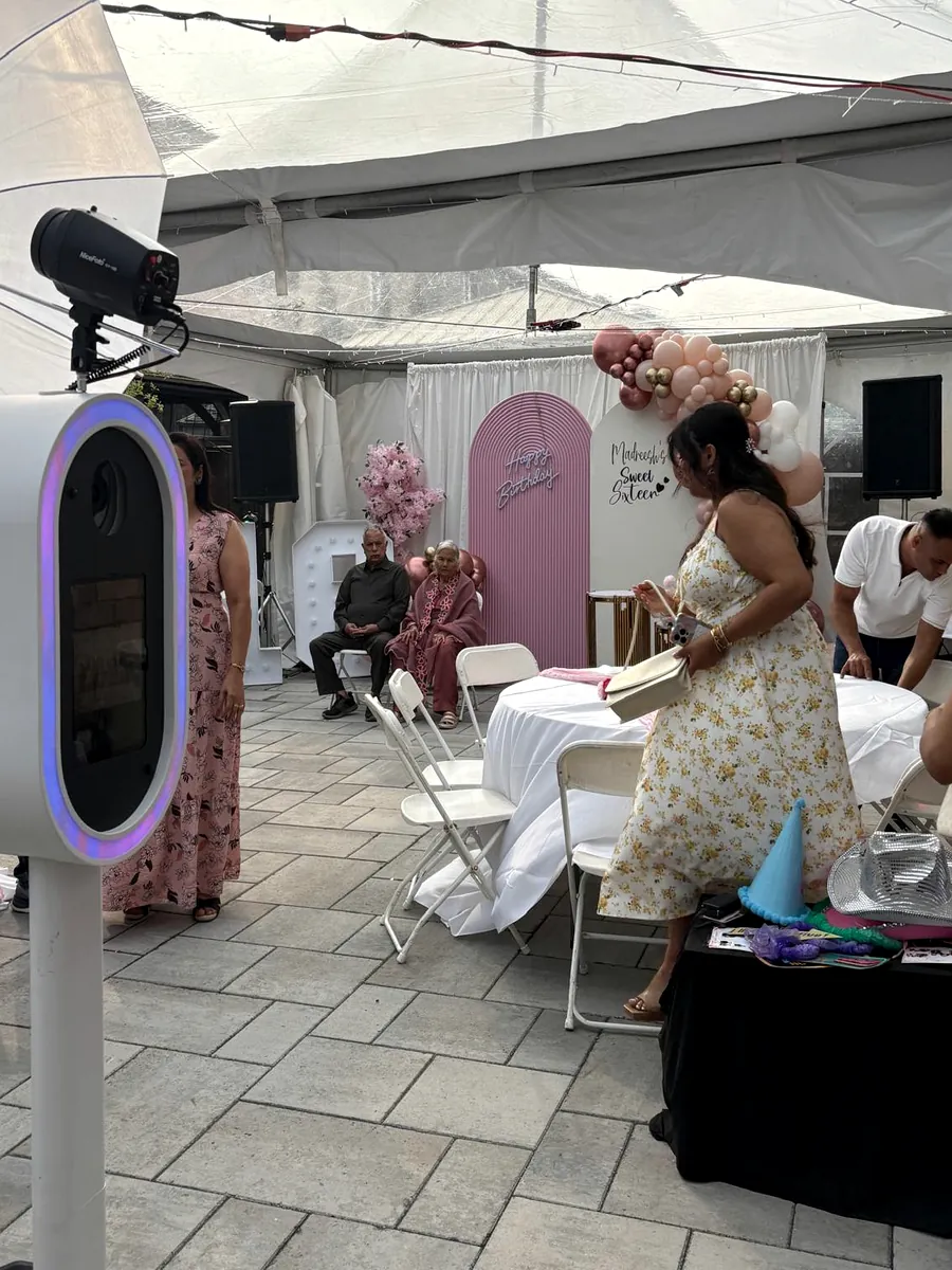 Photo booth at a Sweet Sixteen under a marquee
